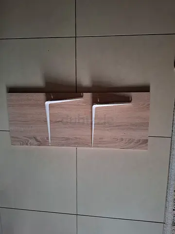 Wooden wall shelf panel with two white metal brackets