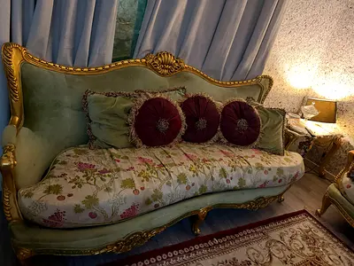 Vintage French-style carved wooden sofa with floral upholstery