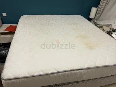 Queen mattress in good structural condition — some surface stains