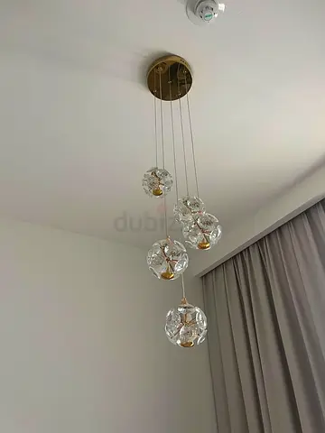 Gold pendant chandelier with five hanging orbs