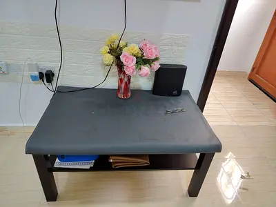 Small black coffee table with lower shelf — good condition