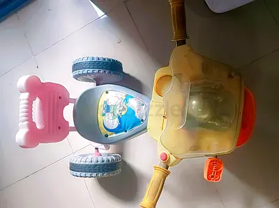 Music cycle .......Used plastic ride-on tricycle for toddlers, lights and storage compartment
