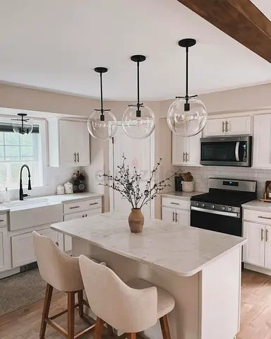 Modern white kitchen island with marble top and storage