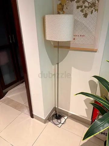 Slim chrome floor lamp with textured white drum shade with led bulb included.