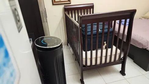Dark wood baby crib in good condition
