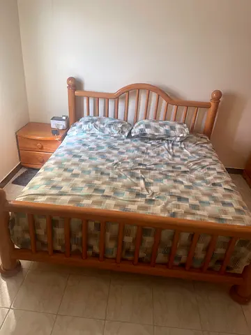 Bed with mattress and side table