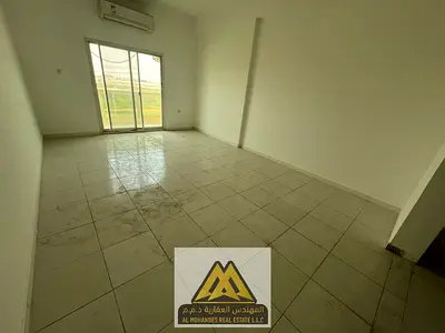 Two-bedroom apartment with a living room and four balconies offering different views in Al Muwaihat 3, close to all services and main roads.