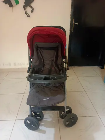 Lightly used red and grey baby stroller - compact, adjustable hood
