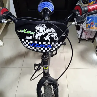 Kids small black BMX-style bicycle with front number plate