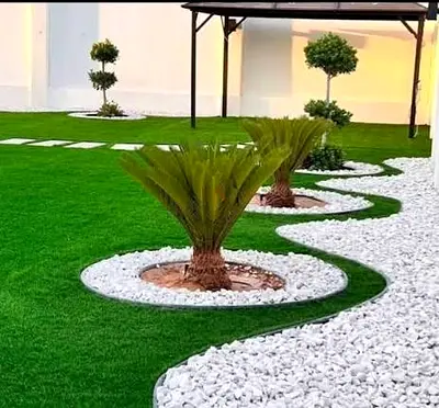 Artificial Grass Lawn with Decorative Pebble Borders and Palm Beds - Ready to Install