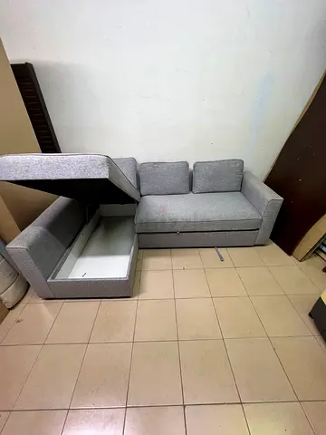 L-shaped grey fabric sofa with storage - good condition