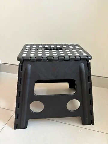 Foldable plastic step stool - compact, black with white dots