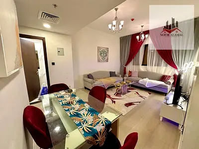 Luxurious furnished one-bedroom apartment with a living room for rent in Al Taawun – new building with parking and a gym.
