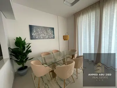 A modern, furnished two-bedroom apartment with a living room is available for annual rent in Al Hamriya, Ajman. It features a direct sea view, private