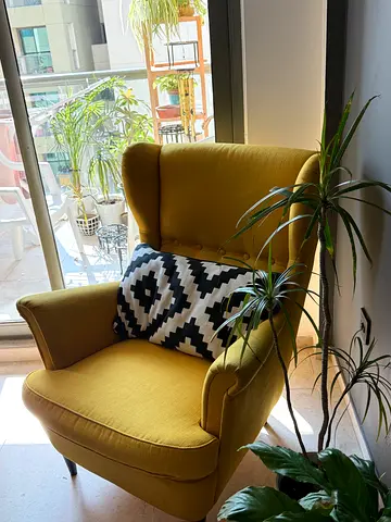 IKEA Yellow upholstered wingback armchair in good condition with pillow
