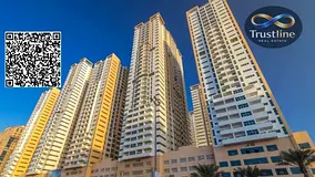 2-bedroom apartment with a living room for sale in Ajman One Tower, featuring city and park views, a