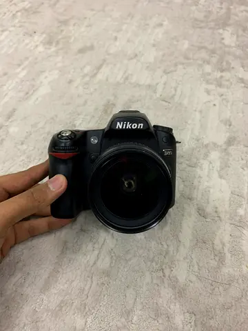 Nikon DSLR with attached lens - used, good condition