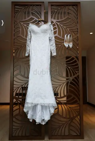 White bridal wedding dress with long train and lace detailing