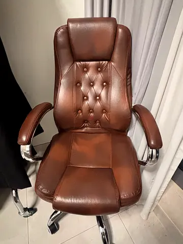Brown leather executive office chair with chrome frame
