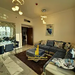 Beautiful furnished one-bedroom apartment with hotel-style furnishings for monthly rent in Ajman - A