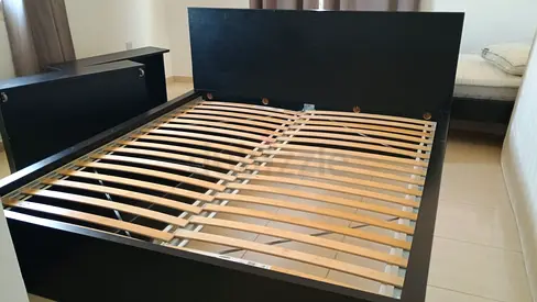 King size wooden bed frame with slats - good condition. Fits two 2/3 mattresses side by side.