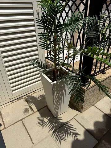 Tall white rectangular planter with artificial palm