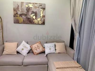 Light grey L-shaped sofa bed with cushions and chaise lounge - Excellent condition