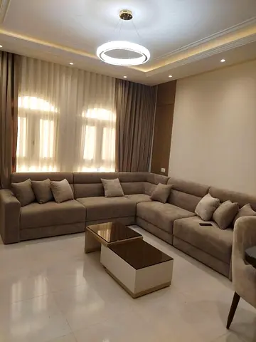 Large L-shaped beige sectional sofa in good condition