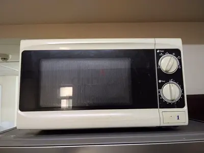 Used White Countertop Microwave Oven - Mechanical Dial Controls