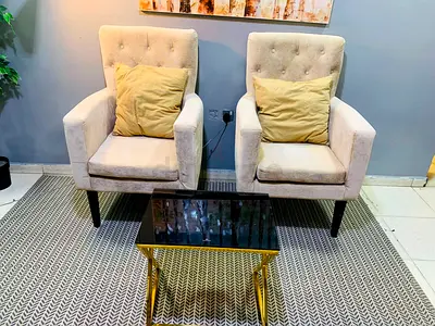 Pair of beige upholstered armchairs with cushions - good condition
