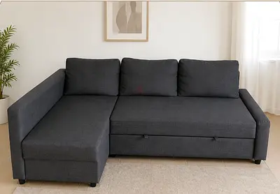Dark grey L-shaped sofa bed with chaise and storage - good condition