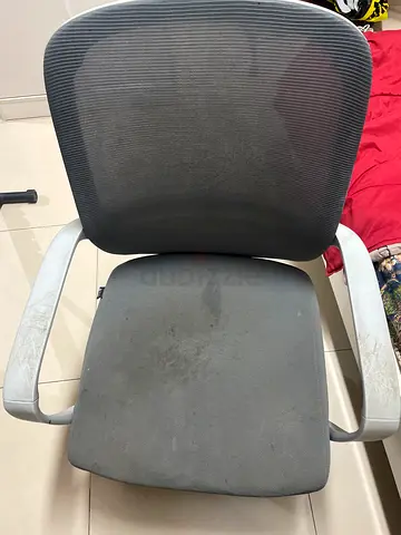 Used grey office chair with mesh back and armrests