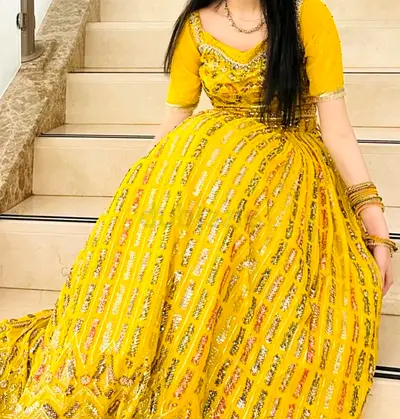 yellow lehenga with full sequin work, matching short choli, and embellished dupatta.