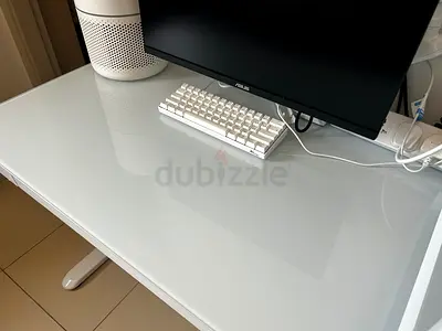 White glass-top computer desk — clean modern standing/sitting desk