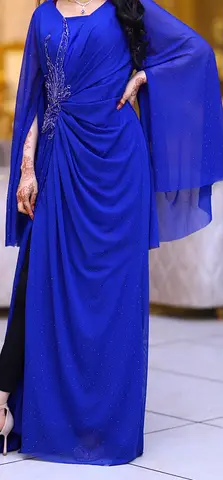 royal blue gown from in love Boutique, fully embellished with shimmering rhinestones and elegant han