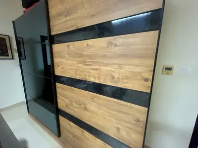 Modern sliding wardrobe with wood and black glass finish - good condition