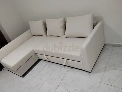 Light beige L-shaped sofa with storage, good condition
