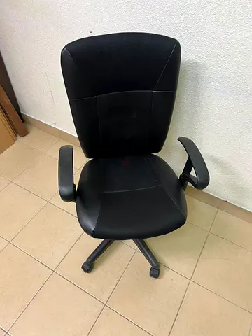 Used black ergonomic office chair with armrests