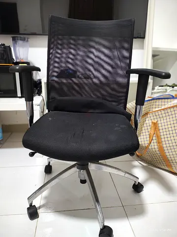 Used black mesh swivel office chair with armrests