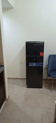 Compact black double-door refrigerator - good condition