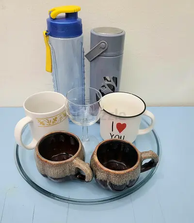 Mixed set of mugs, glassware and travel flasks and plastic storage baskets
