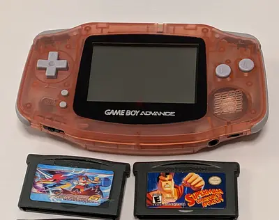 Game Boy Advance (transparent orange) with 2 cartridges - working perfectly