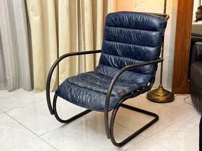Navy Blue genuine leather rocking chair with a bent metal frame