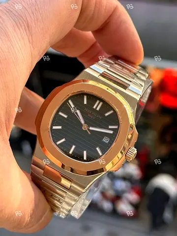 Patek Philippe Nautilus watch appears to be a rose gold model with a brown dial.