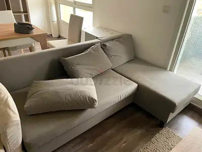 Light grey L-shaped fabric sofa bed with chaise - good condition