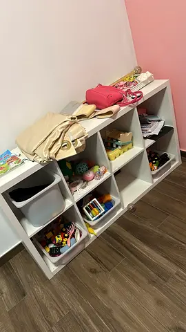 Small cubed toy organizer with assorted kids toys — good condition