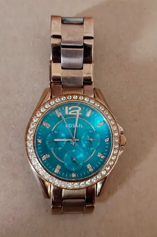 Fossil women's stainless steel watch with turquoise dial and crystal bezel