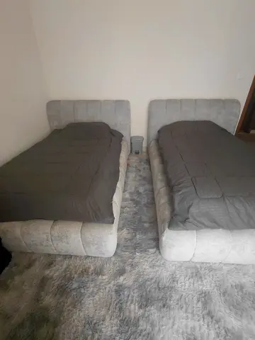 Pair of upholstered single beds with headboards - light grey