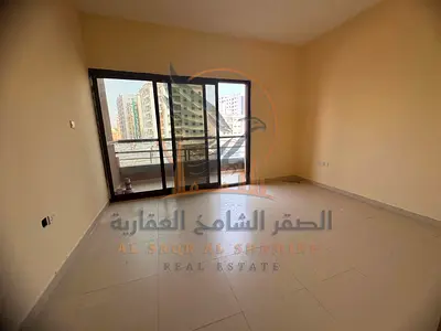 Annual rental apartment in Al Hamidiya with 2 bedrooms, living room, 3 bathrooms, balcony, built-in wardrobes, near Etisalat and the Court.