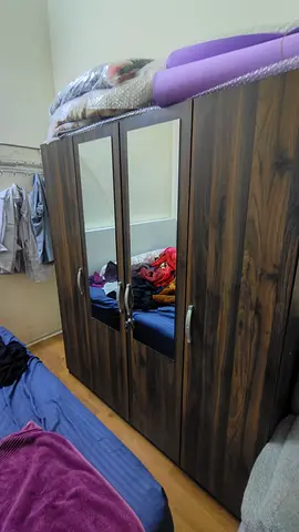Large dark wood 4-door wardrobe with mirror central